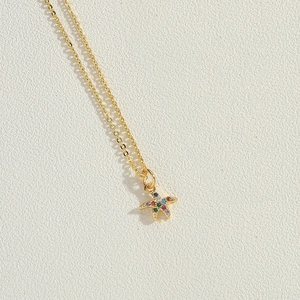 Macro shot of 14K gold plated starfish pendant with colorful cubic zirconia stones