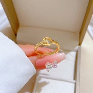 Gold plated T-design open ring with pavé stones shown on a finger with a jewelry box