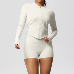 Detail view of double-sided brushed fabric on cream yoga jacket and high-waist shorts set