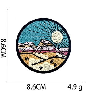 Macro detail of a 8.6cm colorful embroidered mountain patch with fine needlework