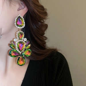 Close-up of oversized teardrop earrings featuring rainbow crystals and sparkling rhinestones