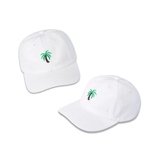 Close-up of white cotton baseball cap featuring green palm tree embroidery detail