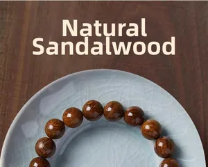 Detailed close-up of natural sandalwood prayer beads on a blue ice-crack ceramic plate