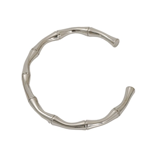 Detail of silver bamboo style open cuff bracelet with polished stainless steel texture