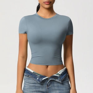 Detail of blue cropped short sleeve fitness top showing tight fit and round neck design