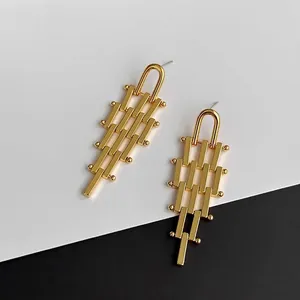 Fashionable golden geometric trapezoid tassel earrings with a modern industrial design