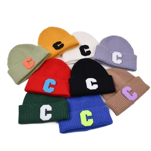 Colorful knitted beanies with letter C patch in nine vibrant assorted winter colors