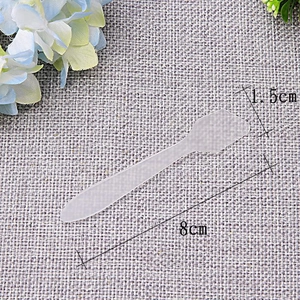 Detail view of 8cm transparent frosted plastic spatula for face cream and masks