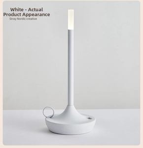Close-up of a white Nordic lamp with frosted metal texture and ring handle detail