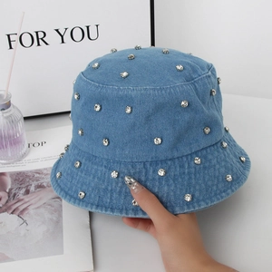Blue washed denim bucket hat with silver rhinestone accents for women in a stylish look