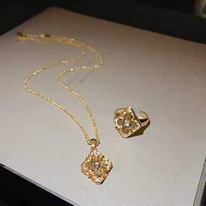 Detailed view of luxury gold-plated floral jewelry set with necklace and ring