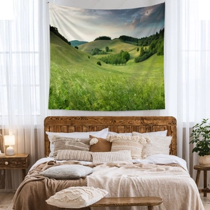 Bohemian forest hills landscape tapestry hanging as a wall decoration in a cozy bedroom