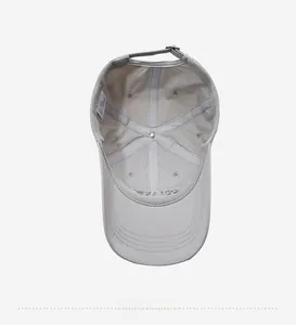 Detailed interior view showing mesh lining, reinforced seams, and strap on the grey baseball cap