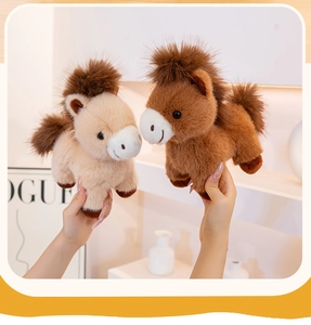 Close-up of beige and brown plush pony dolls showing soft fluffy texture and cute eyes