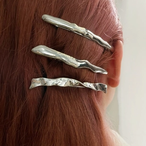Three irregular wave silver metal hair clips with lava texture on red hair