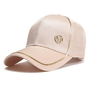 Pink satin baseball cap with golden M badge and elegant silk sheen finish