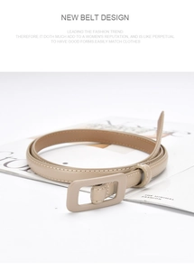 Detail of a beige leather belt with a wrapped buckle on a fashion magazine