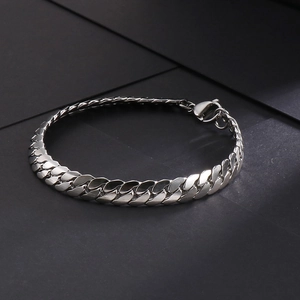 Detailed close-up of a silver stainless steel Cuban link bracelet with lobster clasp