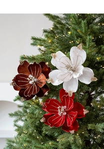 Close-up of velvet Christmas magnolia with gold glitter on a festive decorated tree