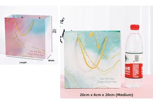 Pink and blue watercolor gift bag size comparison with dimensions 20x8x20cm
