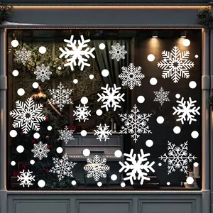 Detailed close-up of white snowflake window clings on a glass pane during Christmas