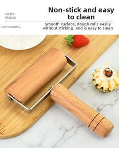 Detail of a beech wood rolling pin with stainless steel bracket on a marble table