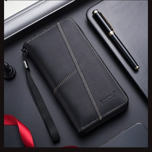 Close-up of black litchi grain leather wallet with metal zipper and wrist strap