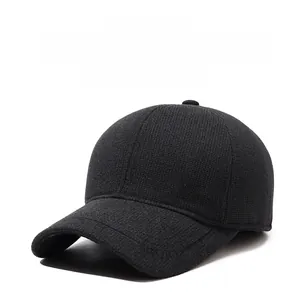 Close-up of black winter baseball cap with ear protection and shield M logo detail