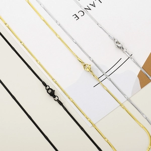 Flat snake chain necklaces in gold, silver, and black stainless steel with lobster clasps