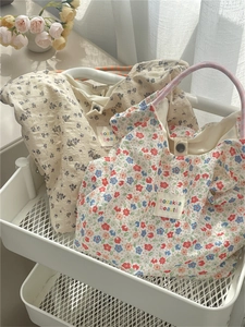 Floral canvas tote bags with colorful flower prints and top handles for summer beach travel