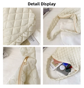 Macro details of quilted cream tote bag showing gold zipper and spacious interior