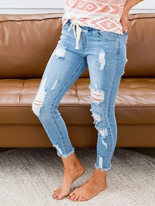 Women's light blue distressed skinny jeans with drawstring elastic waist and ripped knees
