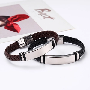 Detail of polished stainless steel plate and woven leather on black and brown bracelets