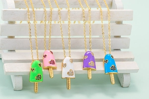Macro shot of colorful popsicle pendants with HAPPY engraving and heart shaped rhinestones