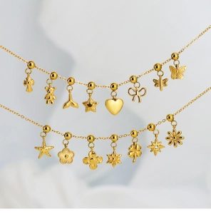 Close-up of golden stainless steel chains featuring butterfly, heart and star charms