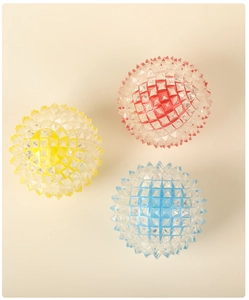 Close-up detail of three colorful spiky massage balls in red yellow and blue colors