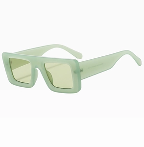 Detailed side view of vintage mint green thick frame sunglasses with yellow lenses