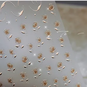 Macro shot of 3D embossed rose gold floral nail art stickers with metallic texture