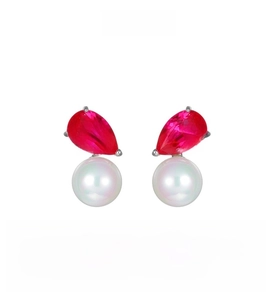 Detail of elegant red pear-cut zircon and white round pearl earring on silver base