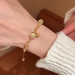 Adjustable crystal beaded bracelet with yellow citrine beads and gold lucky bag charm