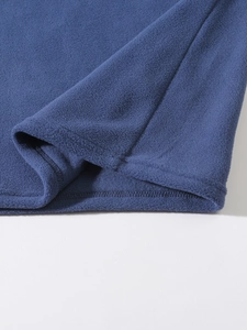 Detail of dark blue coral fleece fabric showing high-density texture and stitching quality