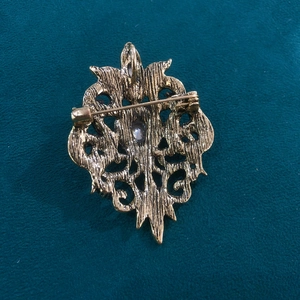 Vintage hollow gold brooch with rhinestones, palace style design and back pin detail