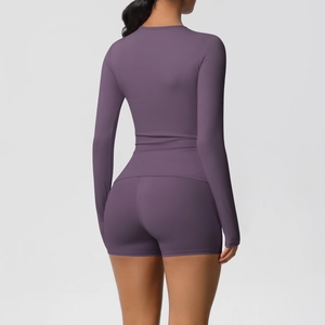 Rear view of purple seamless yoga set with long sleeve crop top and high waist shorts