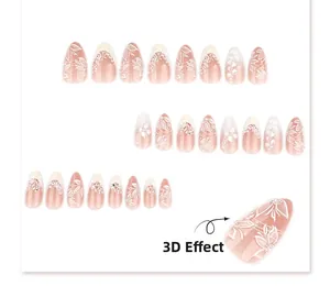 Detail of almond shaped nude pink press-on nails with 3D white lace and pearl accents