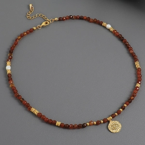 Handmade red agate and pearl necklace with a golden evil eye pendant for a vintage look