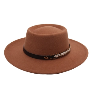Close-up of brown wool felt hat with ethnic woven band and gold metal buckle detail