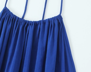 Detailed macro view of deep blue midi dress showing fabric texture and halter strap detail