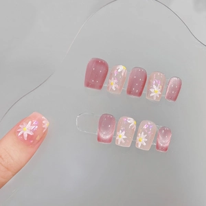 Pink cat-eye press-on nails with hand-painted white daisies in short square-oval shape