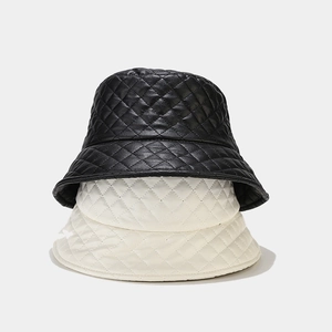 Chic quilted faux leather bucket hats in black and white with elegant diamond patterns