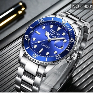 Macro shot of silver stainless steel business watch with blue sunray dial and calendar